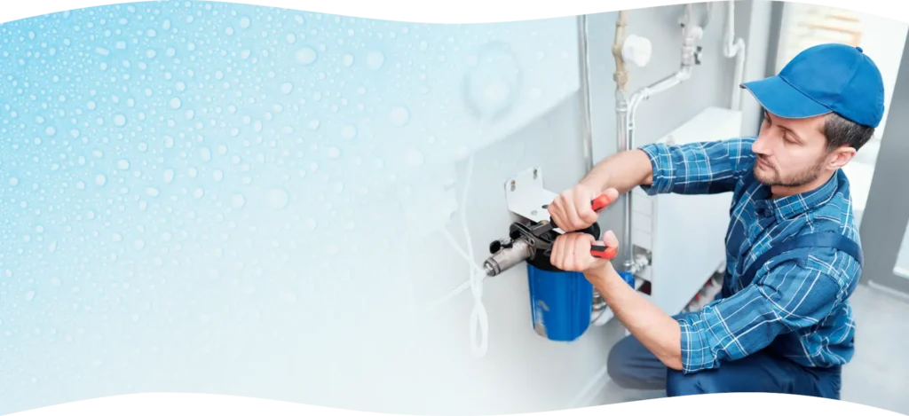 Technician installing water softener